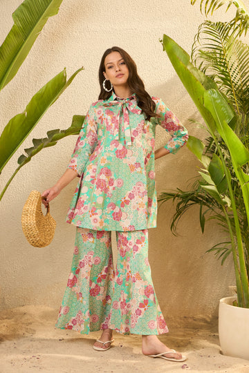 Woman in floral print outfit with straw bag