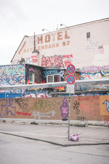 Graffiti-covered building with a hotel sign.